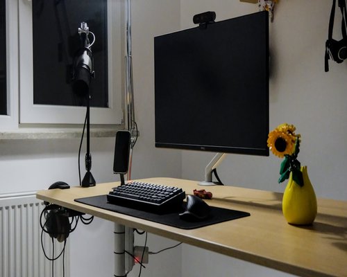 Professional studio workspace with two monitors and an adjustable desk lamp