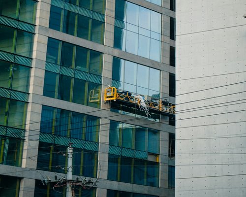 People working in a bright modern environment with large windows