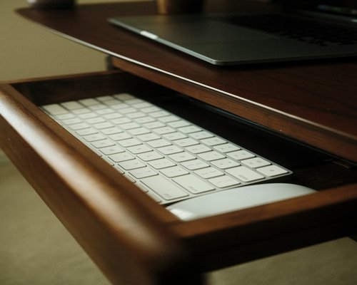 Detailed close-up of an ergonomic laptop stand on a white desk
